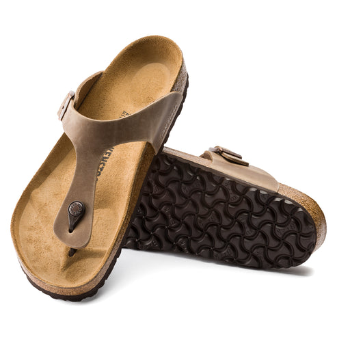 Two toe thong sandals with tan cork soles, one upright and one on its side.