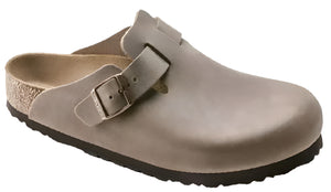 Beige clog shoe with adjustable buckle strap.