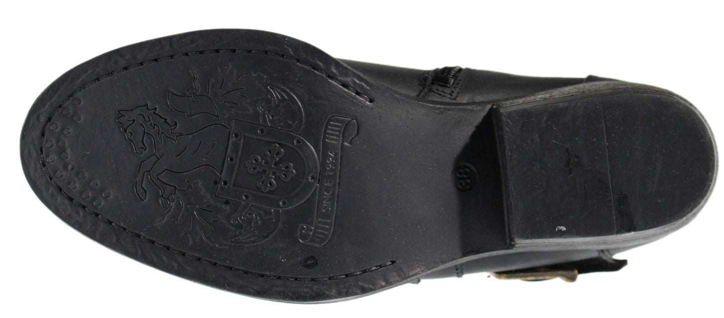 Bottom of a black boot showing embossed design of a horse and shield, stitching along edges, and a block heel.