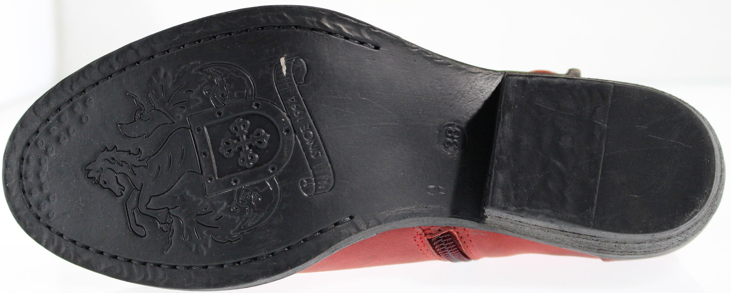 Close-up of a boot sole with an embossed crest design.