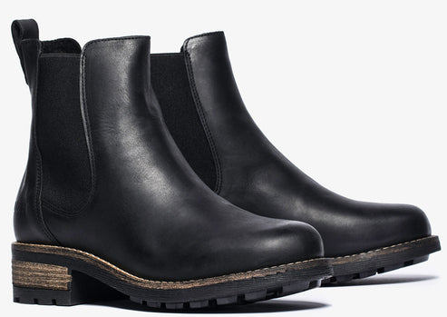 Pair of black leather Chelsea boots with low heel and elastic side panels.