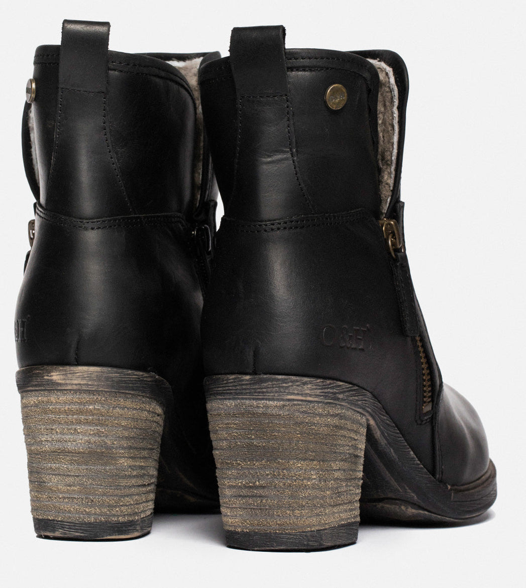 Pair of black leather ankle boots with block heels and side zippers.