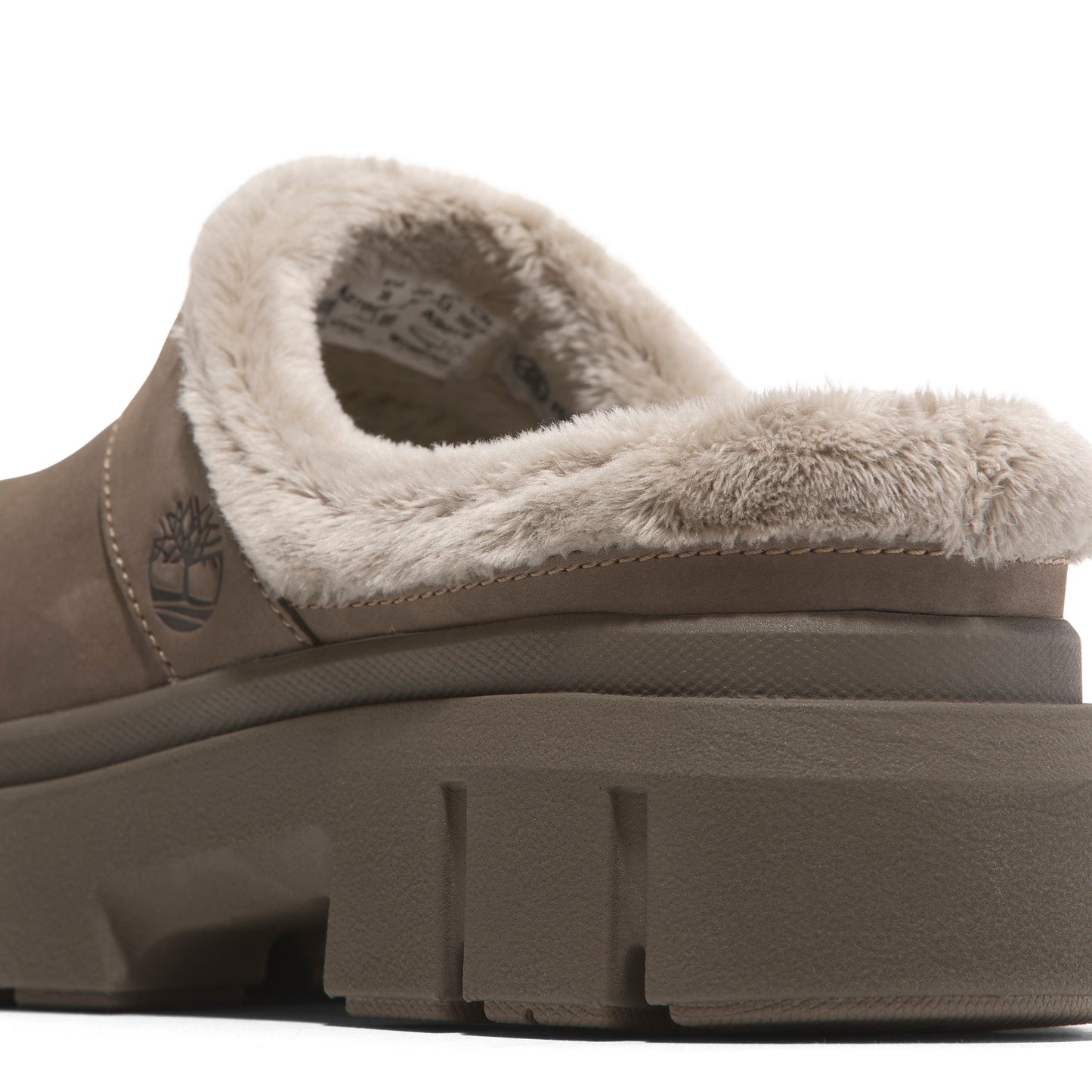 Slip-on shoe with beige faux fur trim and chunky sole.