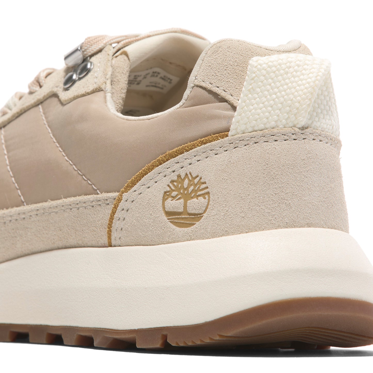 Tan-colored suede and nylon sneaker with textured white heel.