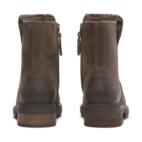 Back view of a pair of brown leather boots with a brown faux fur lining at the top.