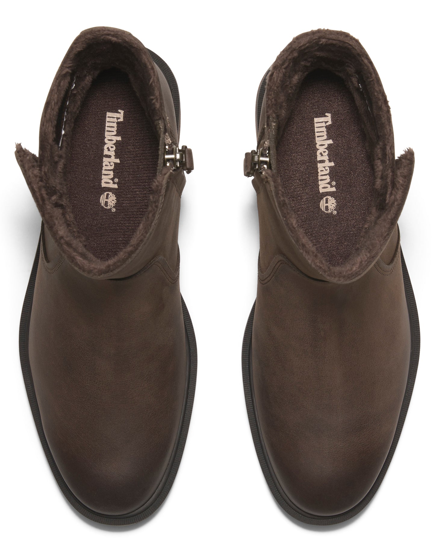 Pair of brown ankle boots with side zippers; insoles display 'Timberland' logo.