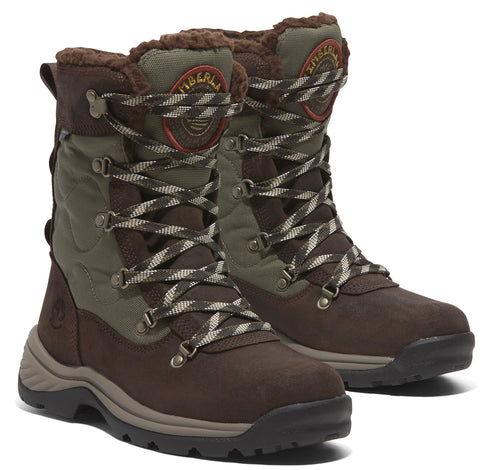 A pair of brown and green winter boots, laced up with white and grey laces, fur lined, showing Timberland logo on the tongue.