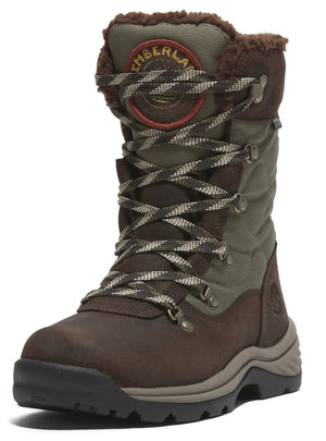 Mid-calf height, brown and green insulated boot with faux fur trim, lace-up closure, and a round, red logo patch on the side.