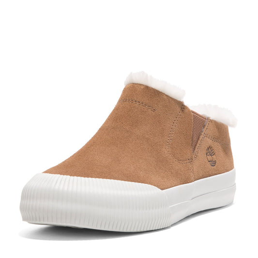 A tan suede slip-on shoe with white trim and faux fur lining.