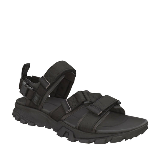 Black sandal with velcro straps and lug sole.