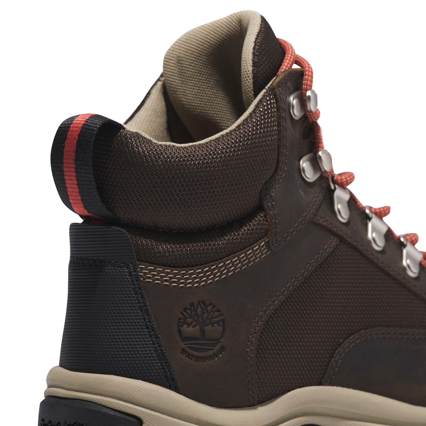 Close-up of a brown, mid-rise waterproof hiking boot with orange laces and silver eyelets; the back has a black and red striped accent above the heel.