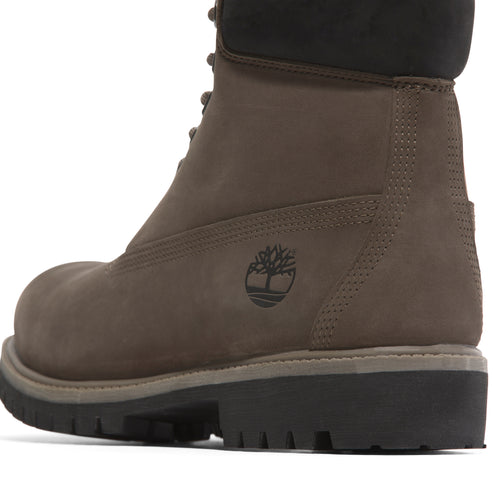 Side view of a dark brown leather boot with a black sole.