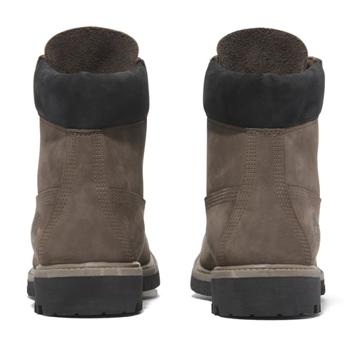Rear view of a pair of taupe Nubuck leather boots with black collars and black lug soles.