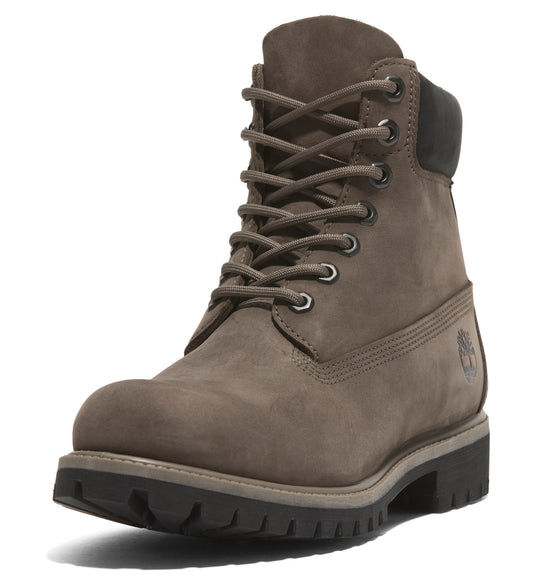 A leather, tan colored boot with laces, a black top and a black sole.