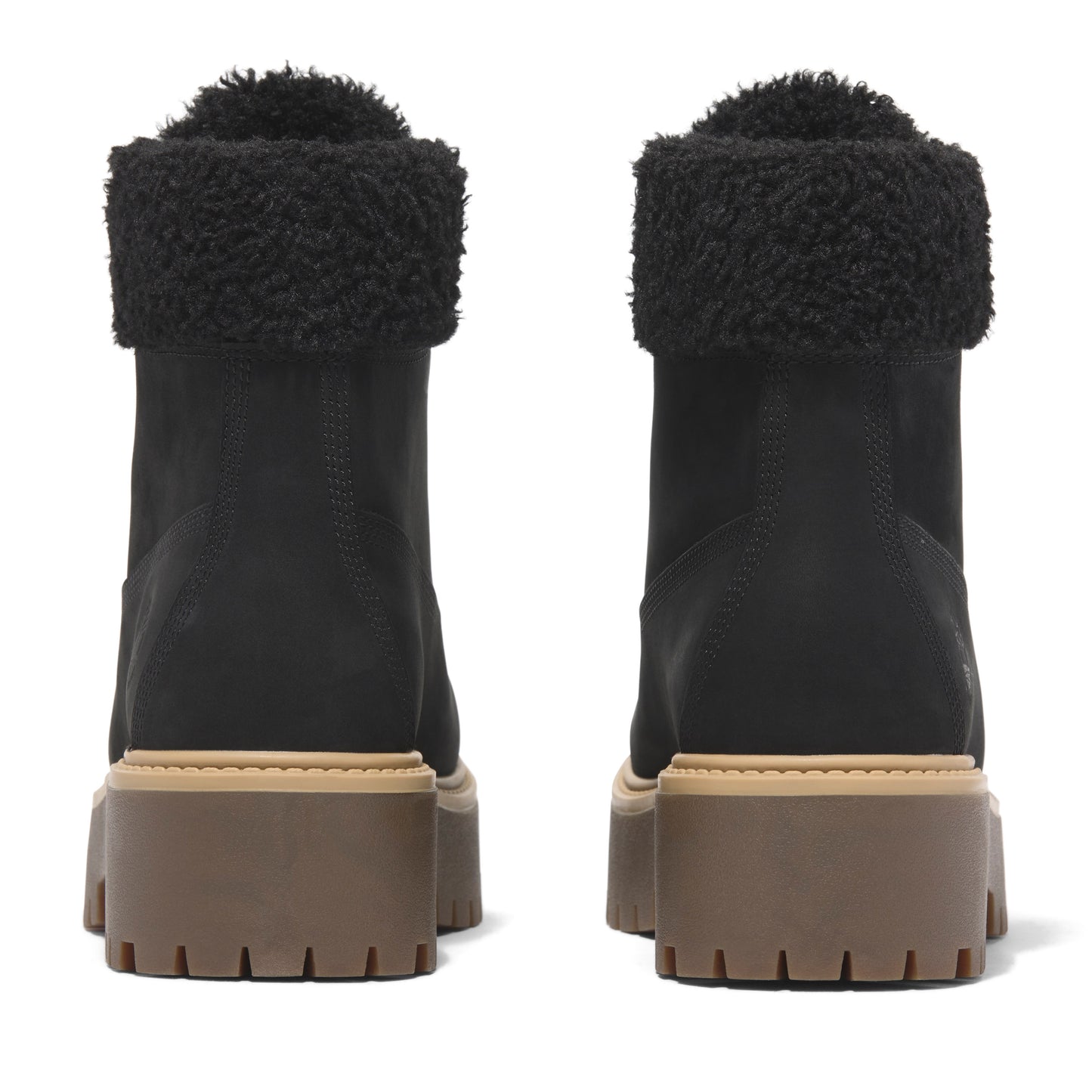 Back view of two black, stacked heel boots with dark fur trim on the top edge.