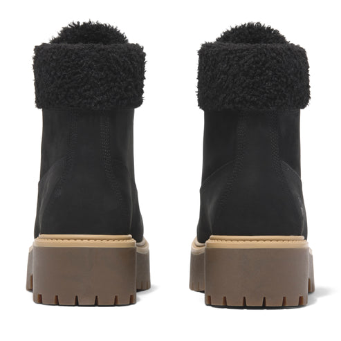 Back view of two black, stacked heel boots with dark fur trim on the top edge.