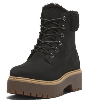 Black ankle boot with platform lug sole and fur-lined top.