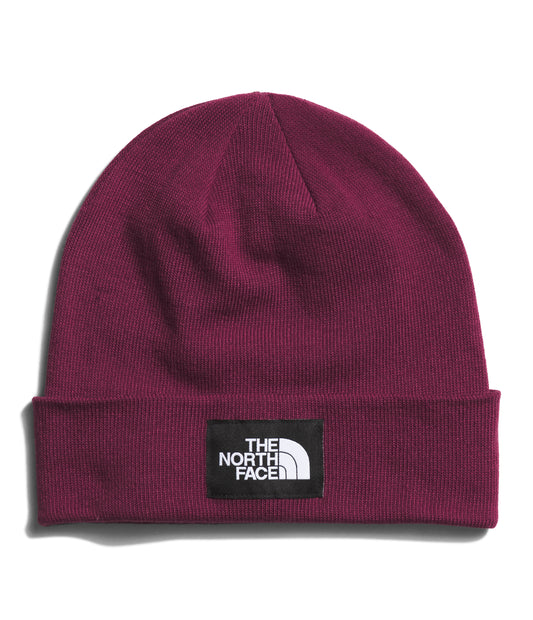 Maroon knit beanie with a black rectangle patch with white text reading "THE NORTH FACE".