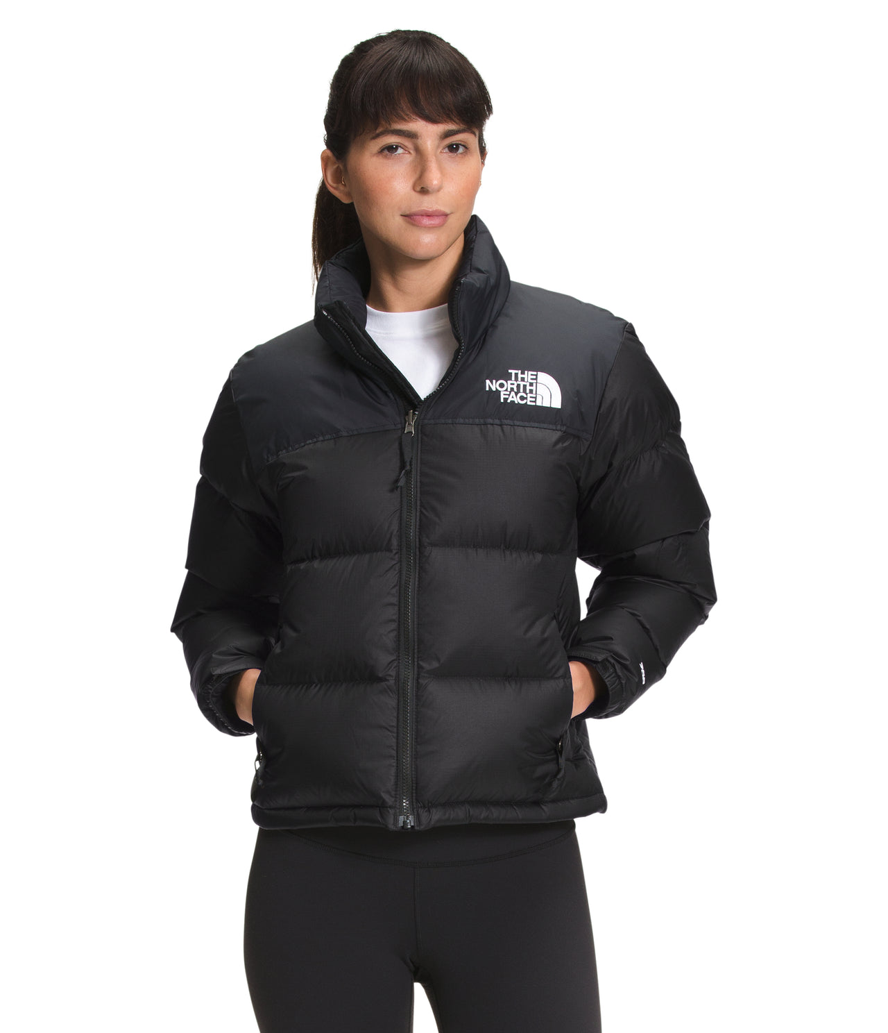 A woman in a puffy black jacket with a white logo on the upper right chest.