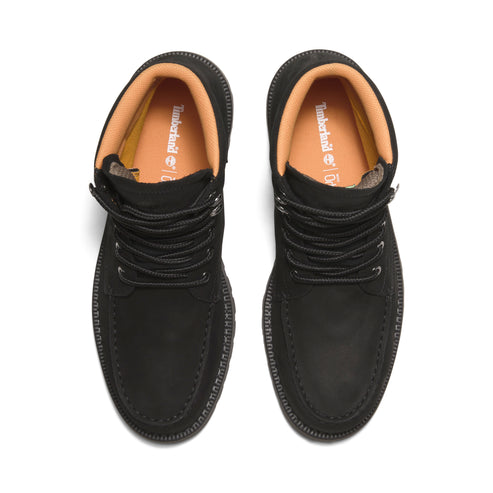Black suede chukka boots with black laces and light orange lining.
