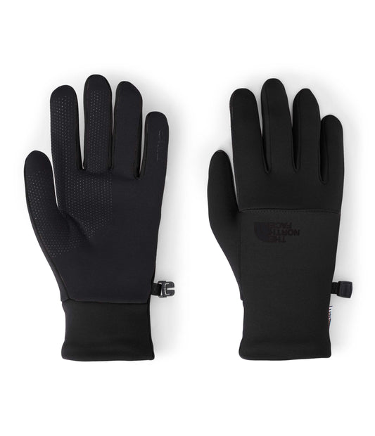 Pair of black gloves, showing front and back. Each glove has five fingers. The front glove has small, dotted grip pattern on the palm and fingers. The back glove shows the logo in the center of the palm. The gloves have wrist straps.