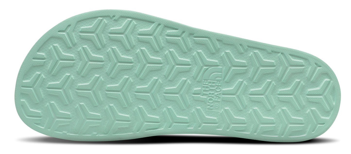 The light green sole of a shoe with a repeating textured pattern.