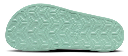 The light green sole of a shoe with a repeating textured pattern.