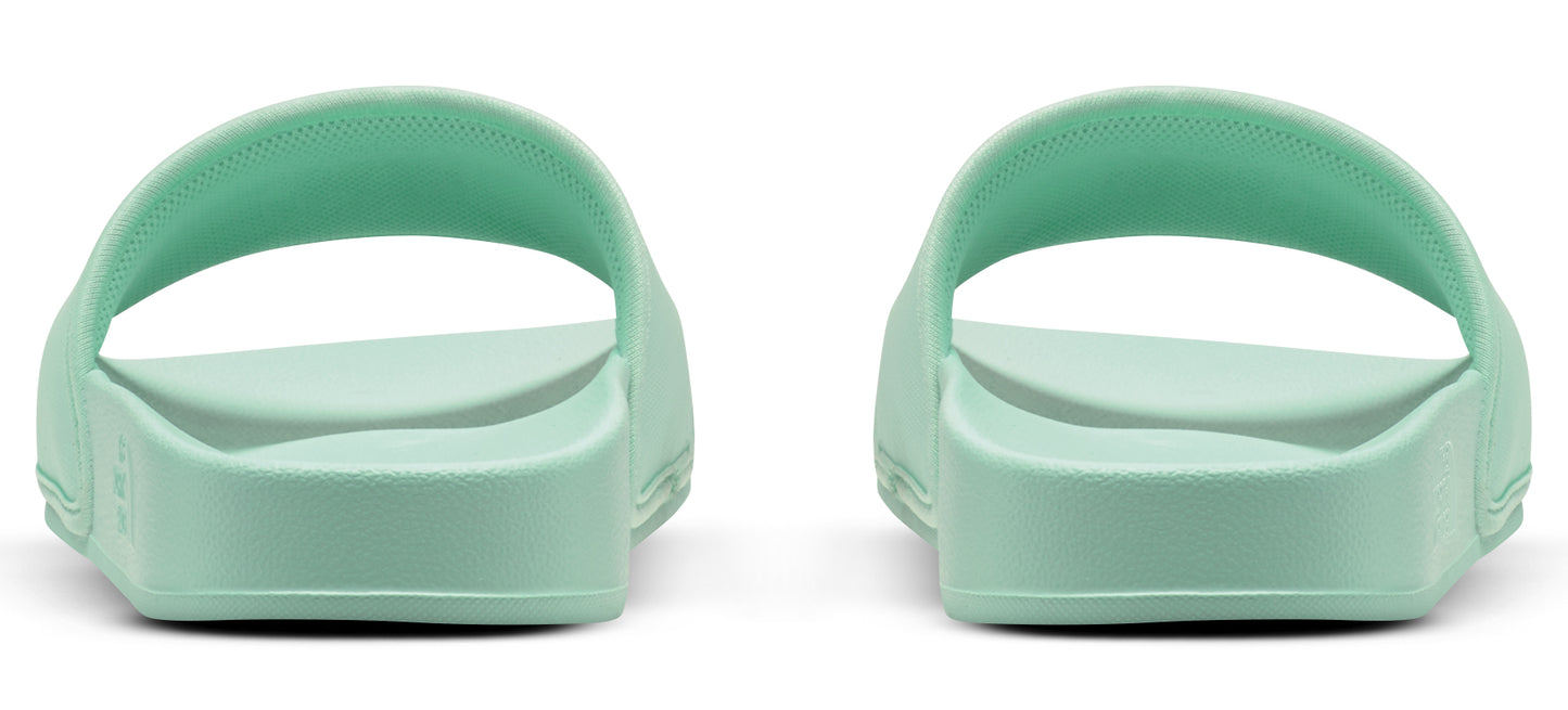 A pair of light green sandals with no straps, seen from the back.