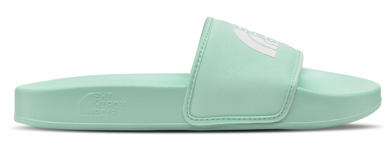 A mint-colored slide sandal with a white logo on the upper.