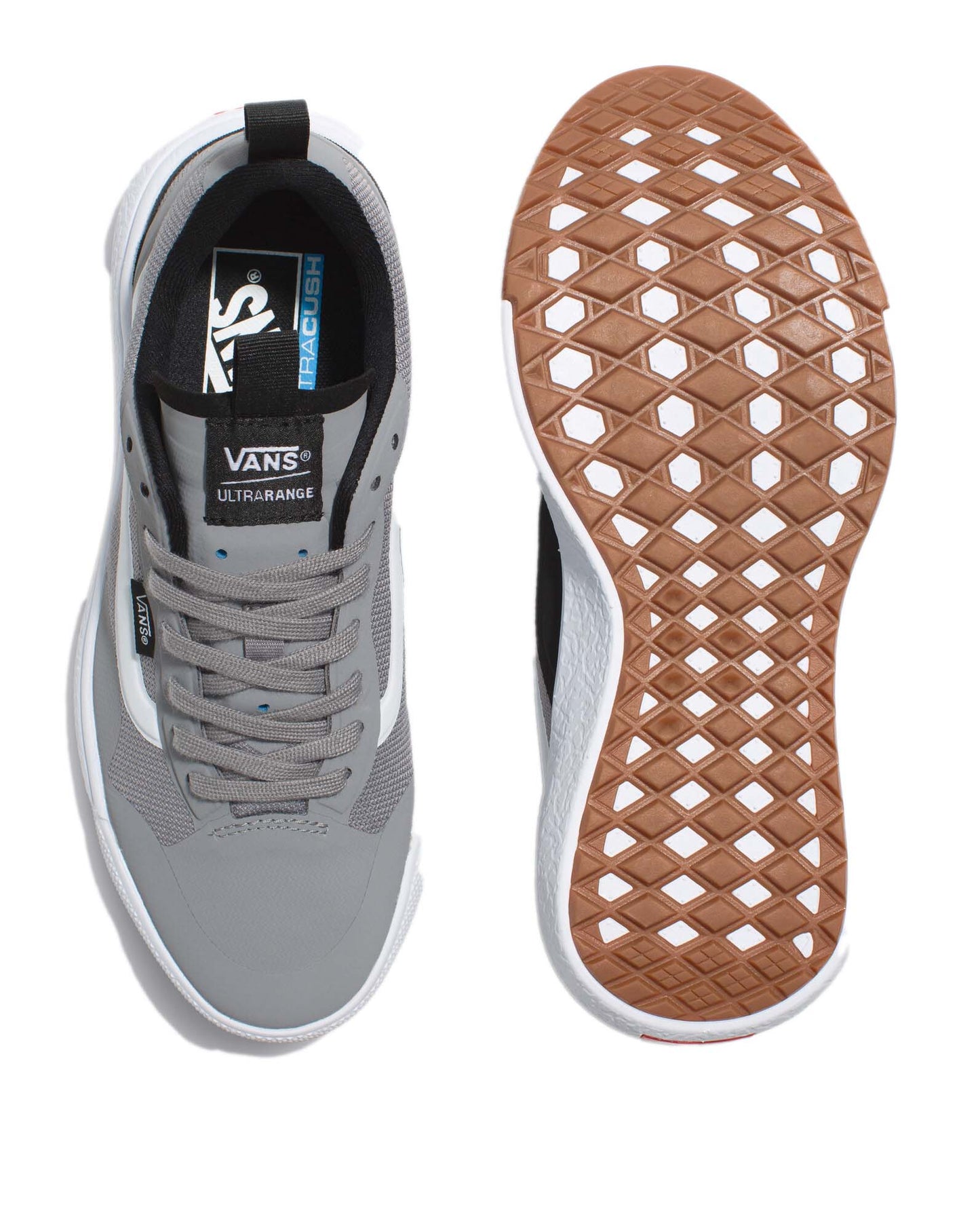 Top view of gray sneakers with white soles, gray laces and black lining. One shoe is upright, the other is sole up showing a brown tread pattern.