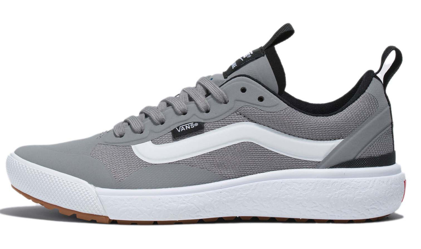 A gray running shoe with a white stripe and white sole.  VANS is visible on the shoe.