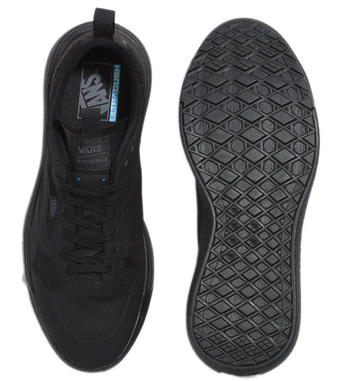 Two black shoes, one showing top with laces and pull tab, one showing sole with geometric tread.