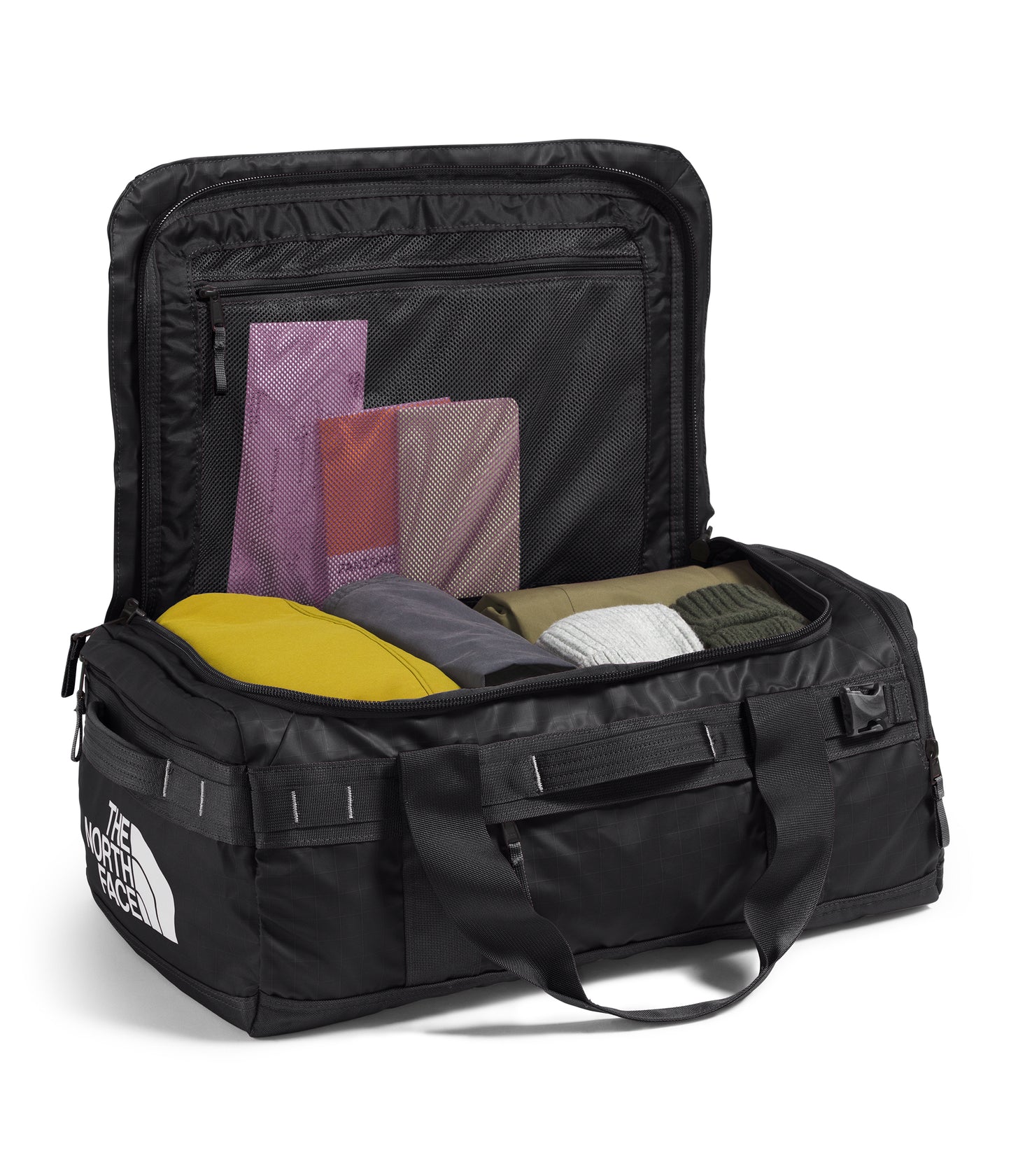 Open black duffel bag with packed clothing, top zippered mesh pocket.