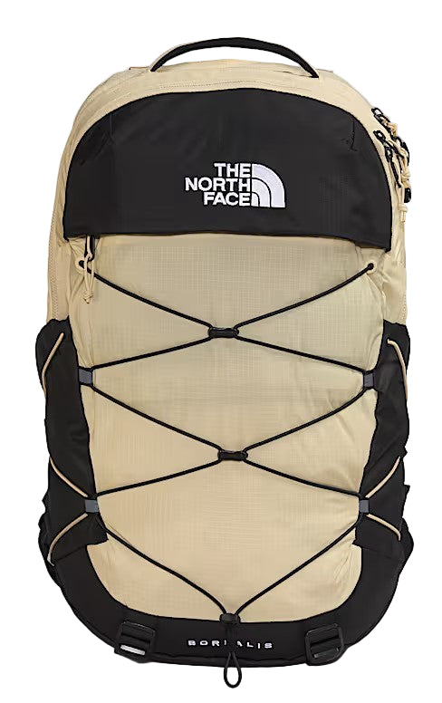 A tan-and-black backpack with bungee cords across the front, and the text "THE NORTH FACE" printed in white.