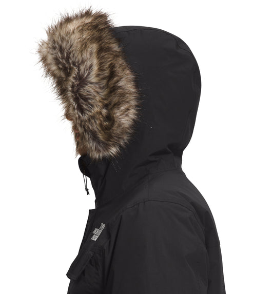 Side profile of a black hooded winter coat with fur trim on the hood.