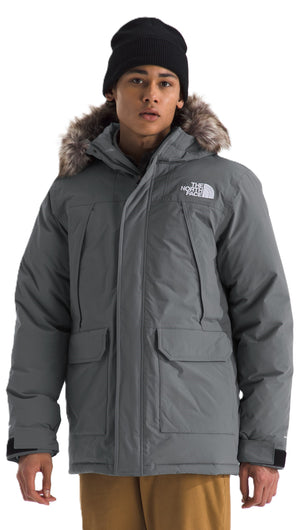 A man wearing a gray, fur-trimmed parka and black beanie.