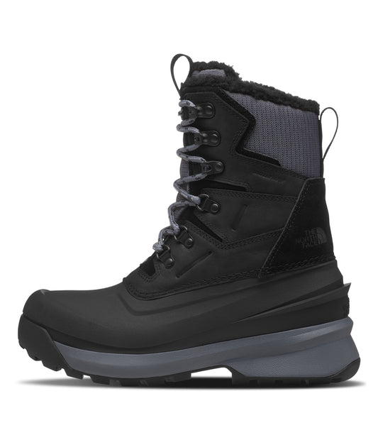 Black mid-calf, lace-up winter boot with grey soles.