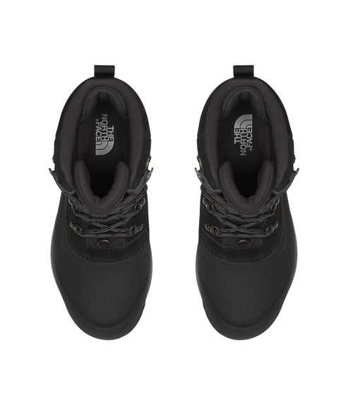 A pair of black, high-top boots with laces.