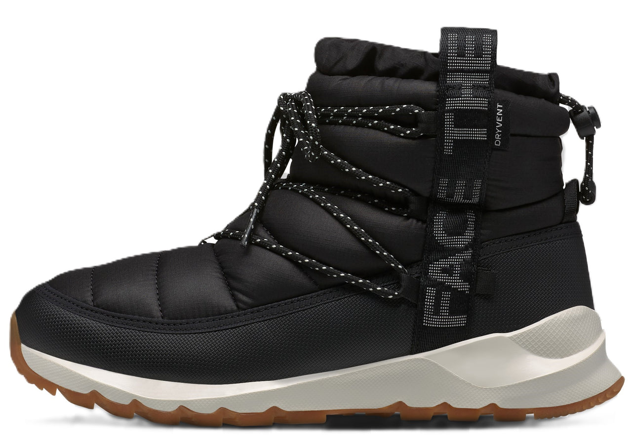 Black insulated puffy boot with laces and cream-colored sole, displaying the text "THE FACE" vertically.
