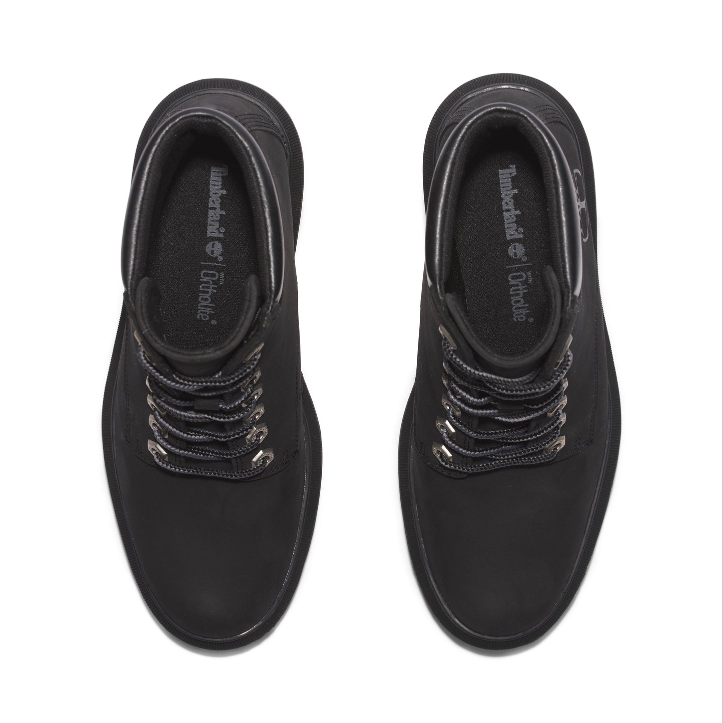 Top-down view of black ankle boots with OrthoLite insole and metal eyelets for laces.