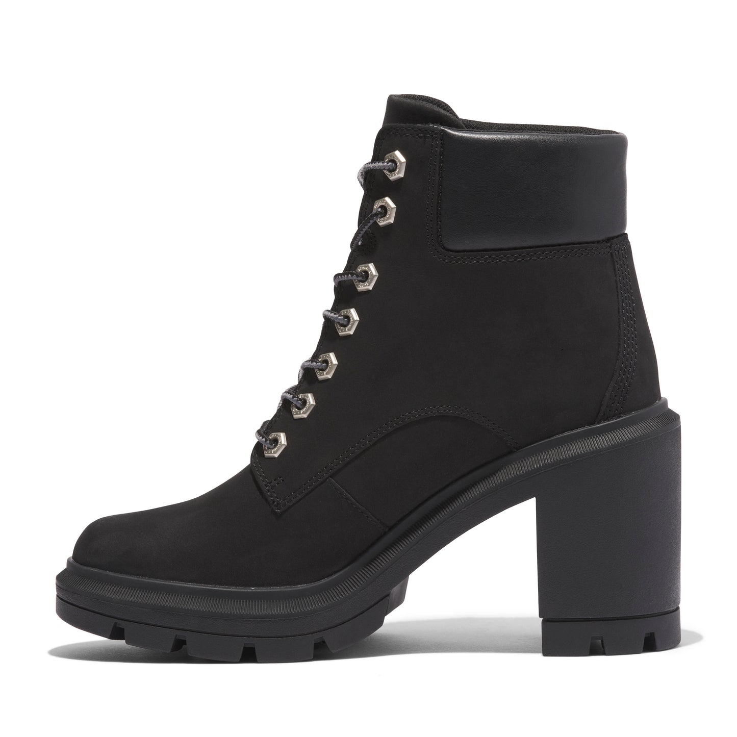 Black heeled combat boot with lug sole and silver eyelets.