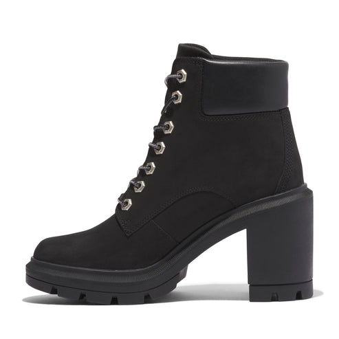 Black heeled combat boot with lug sole and silver eyelets.