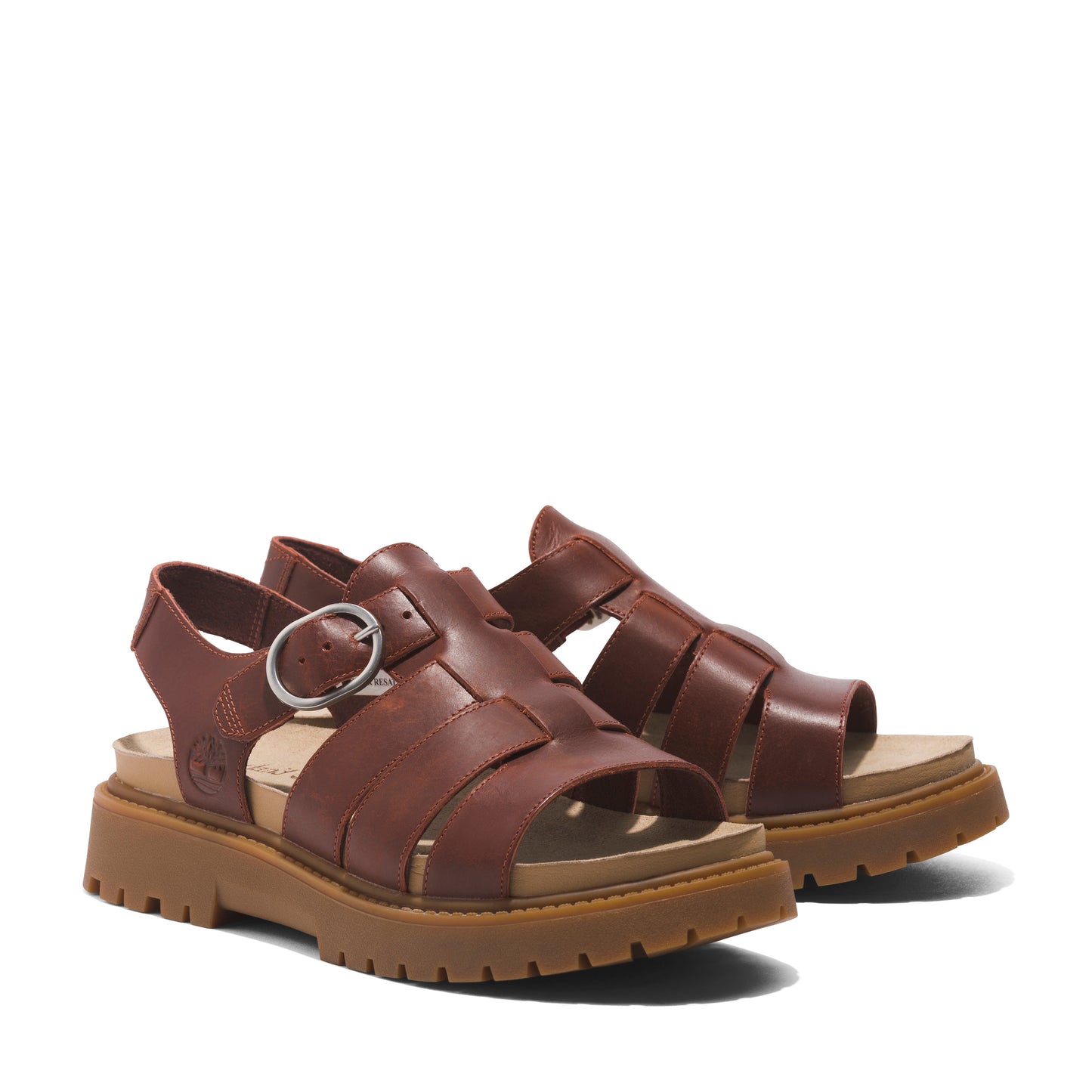 Pair of brown leather fisherman-style sandals with buckle closure and lug soles.