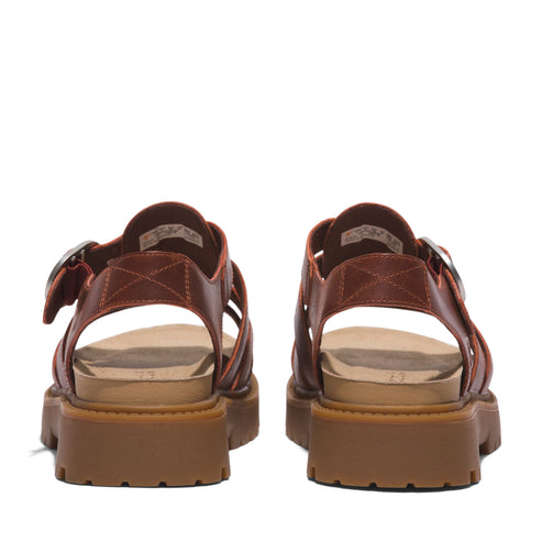 Pair of brown leather sandals with buckle straps and thick lug soles viewed from the rear.