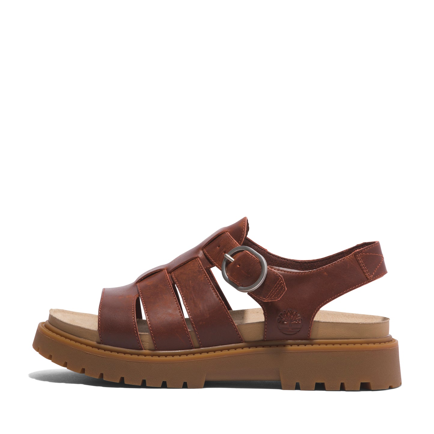 Side view of brown, leather sandal with adjustable buckle and thick lug sole.