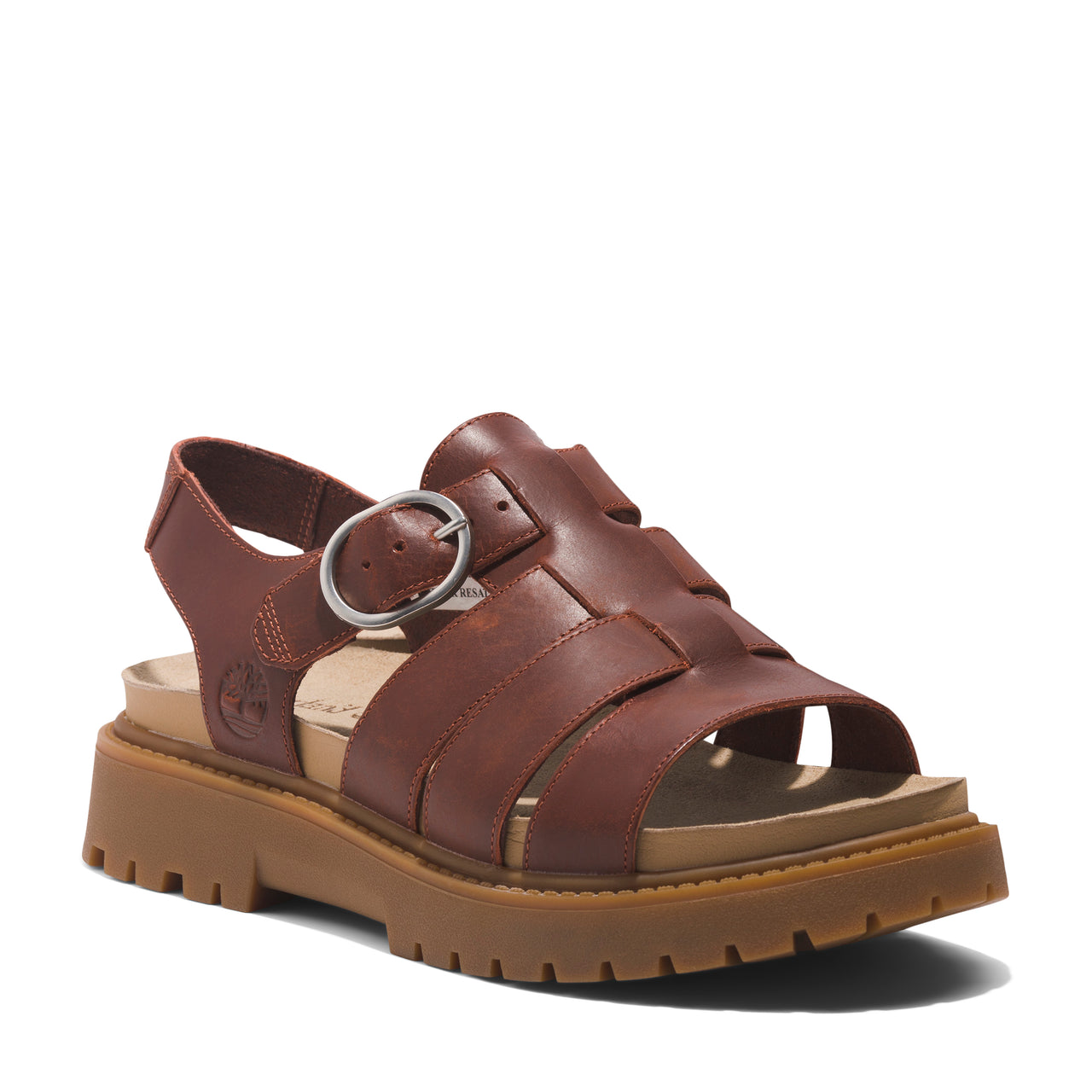 Leather sandal featuring a decorative buckle, a woven leather upper, and a thick lug sole.