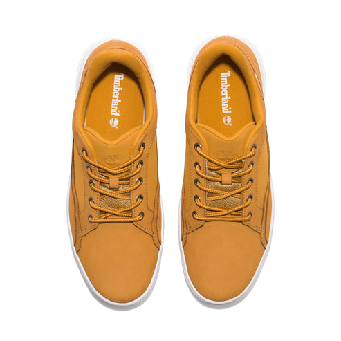Top-down view of a pair of tan sneakers with laces, white soles, and visible 'Timberland' branding.