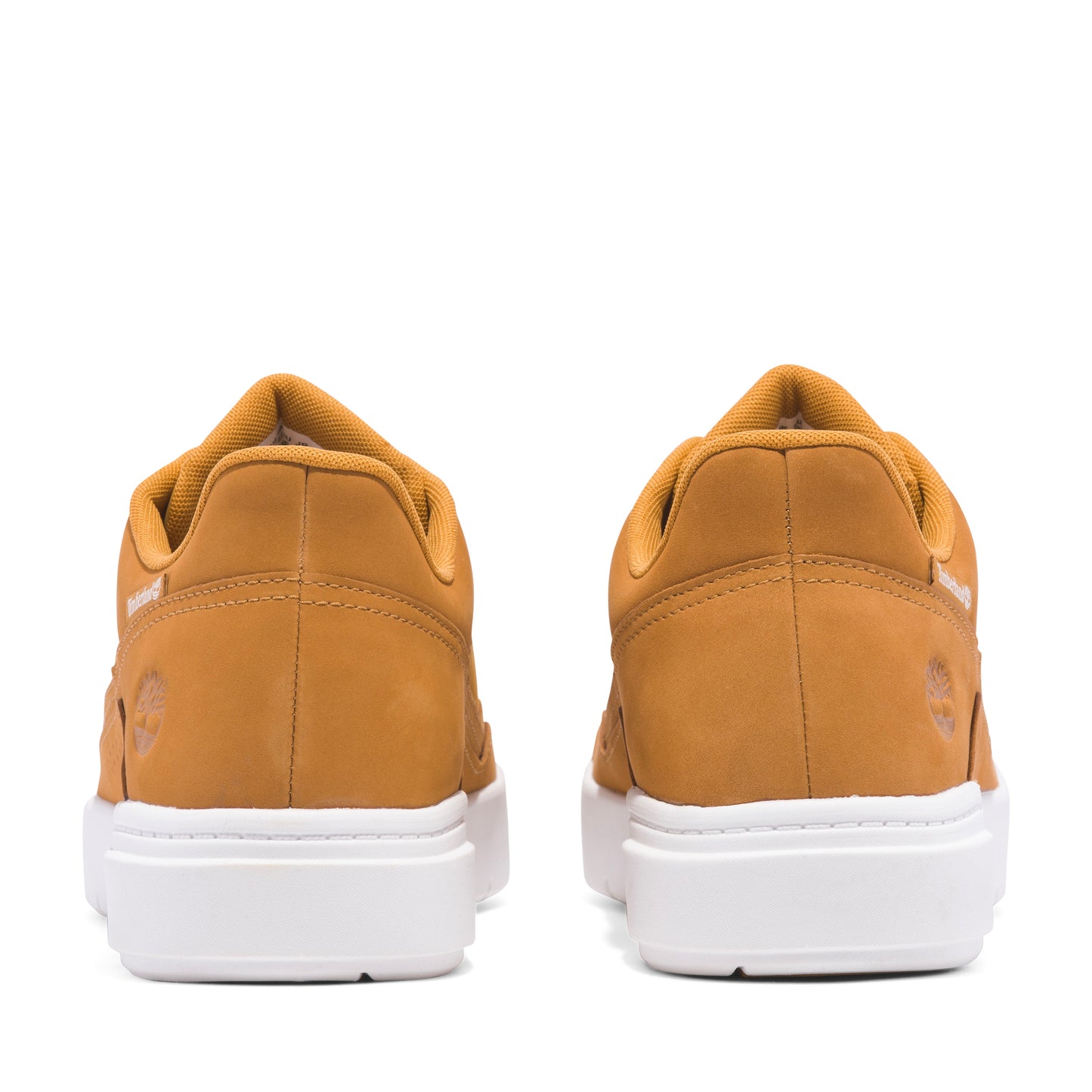 Two tan-colored, low-top sneakers with white soles, viewed from the rear.