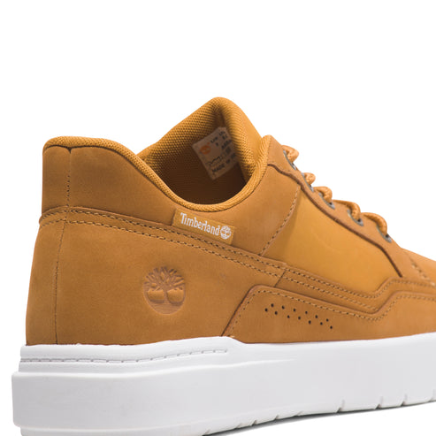 Timberland shoe, yellow-brown, white sole, visible logo.
