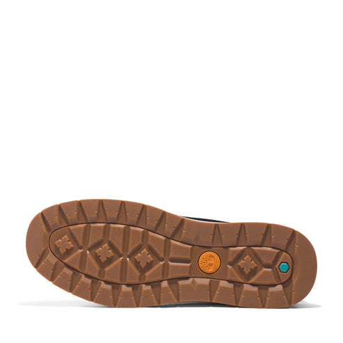 Sole of a brown boot with diamond and flower patterns.